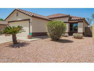 Charming single-story home featuring a tile roof, two-car garage, and low maintenance desert landscaping at 3032 W Red Fox Rd, Phoenix, AZ 85083