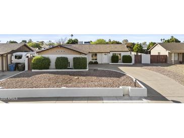 Charming single-story home featuring a well-maintained yard with mature landscaping at 3754 W Hearn Rd, Phoenix, AZ 85053