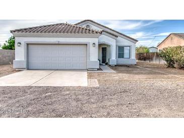 Charming single-story home with tile roof, two-car garage, and low maintenance front yard at 5230 E Pony Track Ln, San Tan Valley, AZ 85140