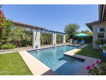 Sparkling swimming pool with built-in fountains and pergola providing shade and elegance at 5515 S Caisson Way, Mesa, AZ 85212