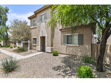 Charming two-story home featuring a front yard with low-maintenance desert landscaping at 21973 N 102Nd Ln # 411, Peoria, AZ 85383