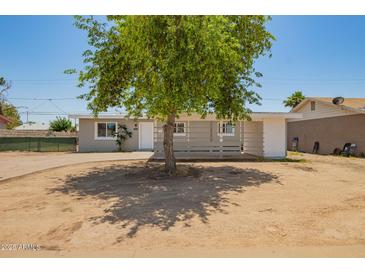 Charming single-story home featuring a well-maintained front yard and a welcoming entrance at 5029 W Osborn Rd, Phoenix, AZ 85031