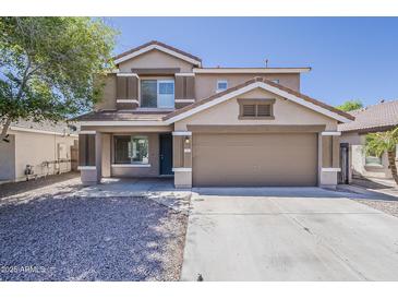 Two-story home with a two-car garage, neutral color palette, and low-maintenance landscaping, exemplifying suburban charm at 763 E Maddison St, San Tan Valley, AZ 85140