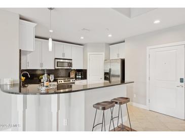 Modern kitchen with stainless steel appliances and sleek granite countertops, ready for cooking at 945 E Playa Del Norte Dr # 3009, Tempe, AZ 85288