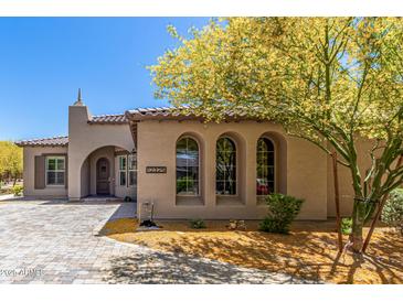 Charming home featuring arched windows, desert landscaping, and a tiled roof at 12325 S 179Th Ave # 29, Goodyear, AZ 85338