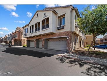 Charming townhouse featuring a blend of stucco and stone accents, plus multiple garages at 1350 S Greenfield Rd # 2133, Mesa, AZ 85206
