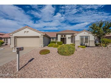 Charming single-story home with desert landscaping and a two-car garage at 15936 W Kino Dr, Surprise, AZ 85374
