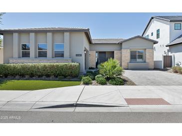 Charming single-story home featuring manicured landscaping, a welcoming entrance, and modern architectural details at 17183 W San Marcos St, Surprise, AZ 85388