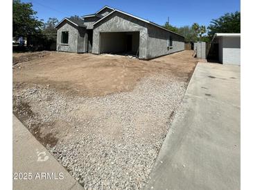Unfinished exterior with a garage and a modern architectural design at 415 S Robert S Rd, Tempe, AZ 85281