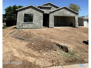 Unfinished exterior view of a single-Gathering home with a two-car garage at 415 S Robert S Rd, Tempe, AZ 85281