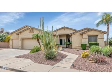 Charming single-story home featuring desert landscaping and a two-car garage at 4239 W Reddie Loop, Phoenix, AZ 85083