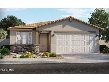 Charming single-story home featuring a two-car garage, stone accents, and a well-manicured front yard at 5561 S 246Th Ave, Buckeye, AZ 85326
