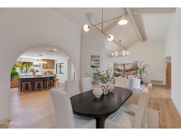 View of the dining room and living room with light wood floors and neutral furniture at 7328 E Laredo Ln, Scottsdale, AZ 85250