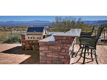 Outdoor kitchen with granite countertop, grill, and bar seating with mountain view at 10841 N Mountain Vista Mtn, Fountain Hills, AZ 85268