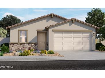 Charming single-story home featuring a two-car garage and stone accents, surrounded by lush landscaping at 17303 W Eva St, Waddell, AZ 85355