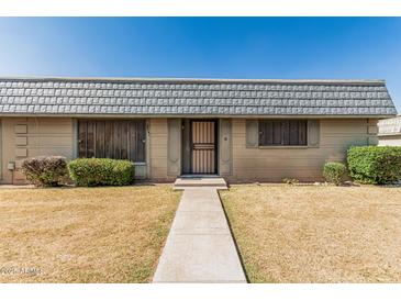 Charming single-story home featuring a desert landscape and a welcoming entrance at 2041 W Pierson St, Phoenix, AZ 85015