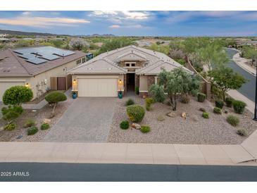 Charming single-story home with well-manicured desert landscaping and a neutral color palette at 31207 N 124Th Dr, Peoria, AZ 85383