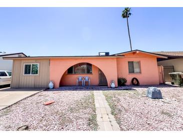 Charming single-story home featuring a unique arched entryway and low-maintenance landscaping at 4623 W Mission Ln, Glendale, AZ 85302