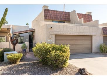 Charming home featuring a two-car garage, complemented by well-maintained desert landscaping in the front yard at 5637 N 78Th Way, Scottsdale, AZ 85250