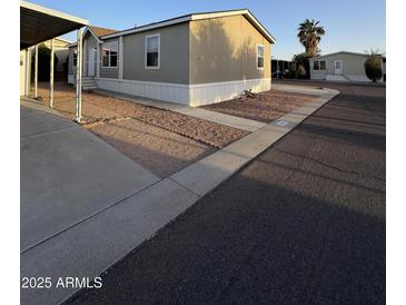 View of a light tan single-story home, with easy-to-maintain gravel landscaping and concrete walkway at 8832 E Pueblo Ave # 20, Mesa, AZ 85208