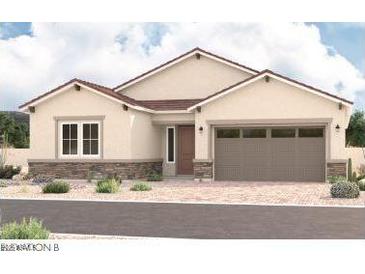 Charming single-story home featuring a two-car garage, neutral stucco, and a well-manicured front yard at 15833 W Bronco Trl, Surprise, AZ 85387