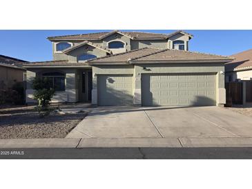 Inviting two-story home featuring a two-car garage and a well-maintained front yard at 18174 E Via Jardin --, Gold Canyon, AZ 85118