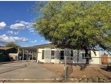 Charming single-story home featuring desert landscaping and a covered parking area, perfect for easy access at 2359 S Tomahawk Rd, Apache Junction, AZ 85119