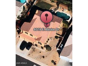 This aerial view showcases a beautiful home with a private pool and well-manicured landscaping at 4018 E Adobe Dr, Phoenix, AZ 85050
