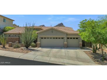 Charming home with a three-car garage and low-maintenance landscaping at 6133 W Fetlock Ter, Phoenix, AZ 85083