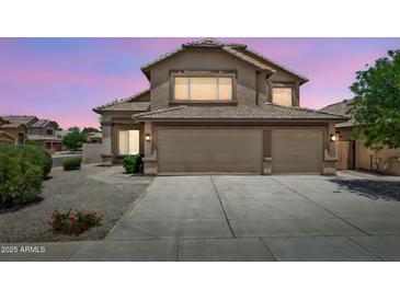 Charming home featuring a well-maintained front yard and a spacious three-car garage at 664 E Windsor Dr, Gilbert, AZ 85296
