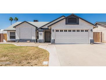 Charming single-story home featuring stucco siding, a two-car garage, and a well-maintained front yard at 676 W Shawnee Dr, Chandler, AZ 85225