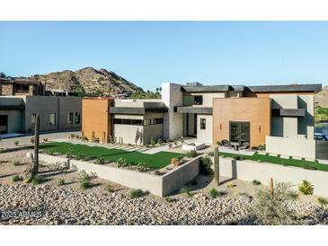 Stunning contemporary home featuring desert landscaping, geometric architecture, and mountain views at 7215 N Black Rock Trl, Paradise Valley, AZ 85253