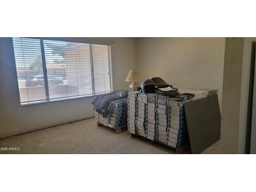 Bright bedroom showing flooring materials stacked on pallets, waiting for install at 7962 W Lincoln St, Peoria, AZ 85345