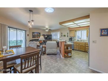 Open living area with a combined kitchen and dining space, featuring modern appliances and comfortable seating at 8160 E Keats Ave # 364, Mesa, AZ 85209
