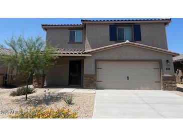 Charming two-story home featuring a two-car garage and desert landscaping at 1074 W West Virginia Ave, Florence, AZ 85132