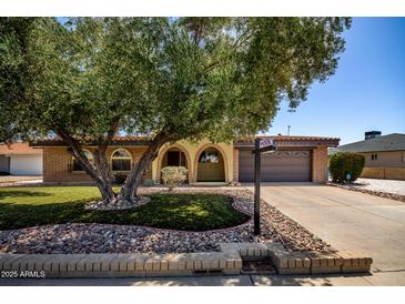 Charming single-story home featuring a well-manicured lawn and inviting curb appeal at 12811 N 44Th Dr, Glendale, AZ 85304