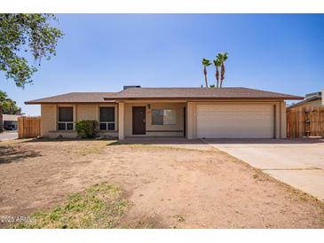 Charming single-story home features a two-car garage and low-maintenance front yard at 18402 N 17Th Ave, Phoenix, AZ 85023