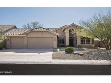 Charming single Gathering home with a three car garage and low maintenance desert landscaping at 18873 N 94Th Way, Scottsdale, AZ 85255