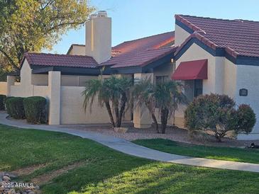 Inviting home exterior with red tile roof, desert landscaping, and a well-maintained lawn at 2123 E Kirkland Ln # 3, Tempe, AZ 85281