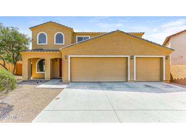 Inviting two-story home with a three car garage and charming curb appeal at 2129 E Yuma Ave, Apache Junction, AZ 85119