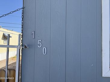 Exterior features the house numbers 150 on the side of the home at 235 W Southern Ave # 150, Mesa, AZ 85210