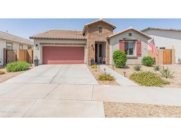 Charming single-story home featuring a welcoming brick entryway and a well-maintained, xeriscaped front yard at 24638 N 144Th Ave, Surprise, AZ 85387