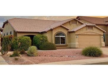 Charming single-story home featuring a well-maintained yard with desert landscaping and a two-car garage at 4322 E Cottonwood Ln, Phoenix, AZ 85048