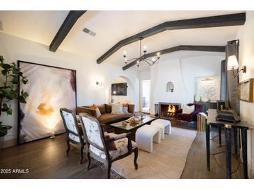Spacious living room showcasing an open floor plan, with a fireplace, and stylish furnishings at 1309 W Lynwood St, Phoenix, AZ 85007