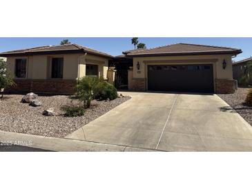 Charming single-story home featuring a desert landscape, tile roof, and attached garage at 15843 W Edgemont Ave, Goodyear, AZ 85395