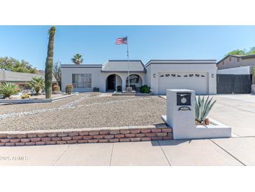 Charming single-story home featuring an arched entryway and low-maintenance desert landscaping at 2033 E Hillery Dr, Phoenix, AZ 85022