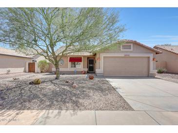 Charming single-story home featuring a low-maintenance desert landscape and a covered entrance at 20739 N 106Th Ln, Peoria, AZ 85382