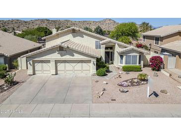 Inviting two-story home with a spacious three-car garage and xeriscaped front yard landscaping at 2629 E Verbena Dr, Phoenix, AZ 85048