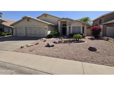 Charming home featuring a low maintenance desert landscape and a three car garage at 2629 E Verbena Dr, Phoenix, AZ 85048
