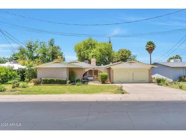 Charming single-story brick home featuring well-maintained landscaping and a spacious two-car garage at 504 N Emerson --, Mesa, AZ 85201